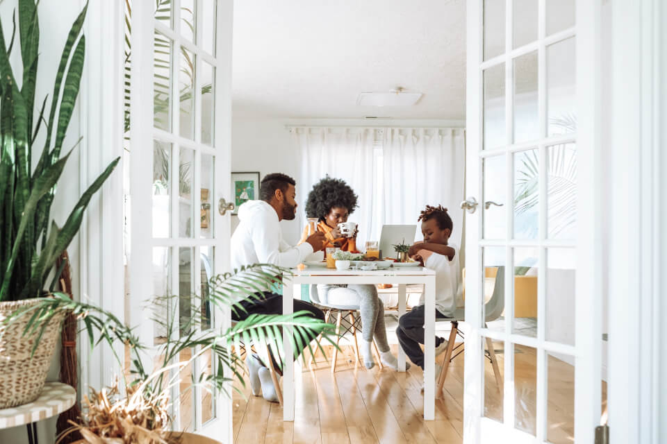 Home Friends sharing a meal around the table in a shared rental house