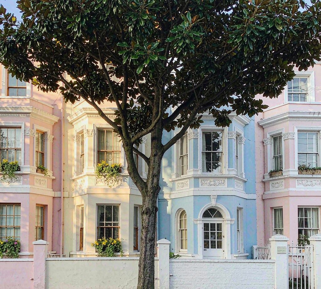 Pastel-painted terraced houses on a street in Notting Hill, London