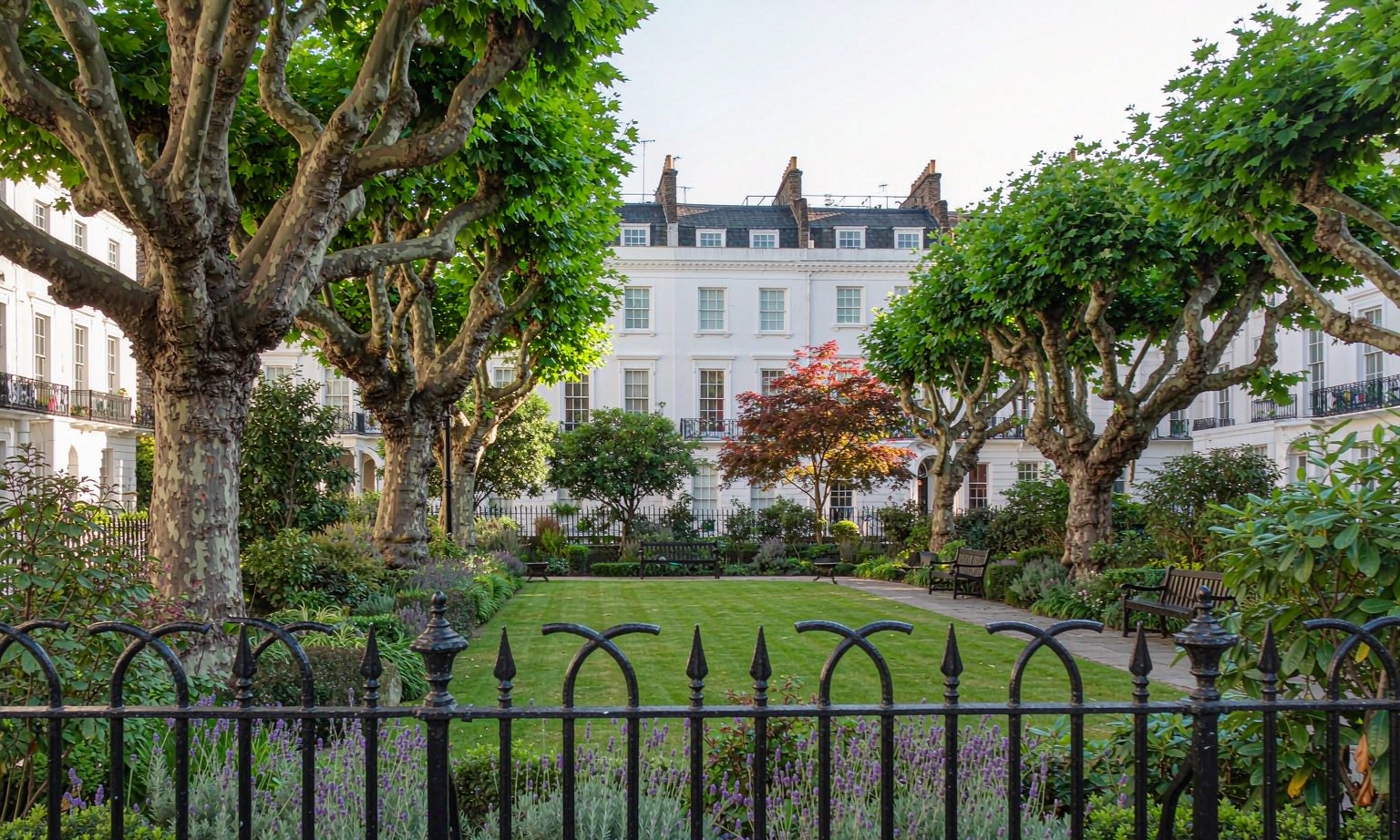 Home A railed garden square in West London with mature trees and stucco terraces behind